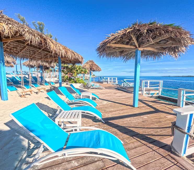 Nassau: Sun Cay Day Trip, Snorkel, Iguana Encounter, & Lunch - Snorkeling with a sailboat, airplane, and sculptures